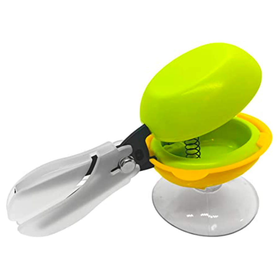 Spring-loaded scissors with an easy-to-depress handle mounted to a surface with a suction cup.