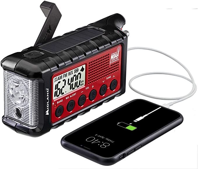 A Midland NOAA weather radio with hand crank and solar panel. It is charging an iPhone.