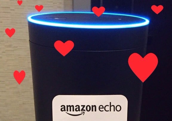 An Amazon Echo with graphic hearts scattered over the image