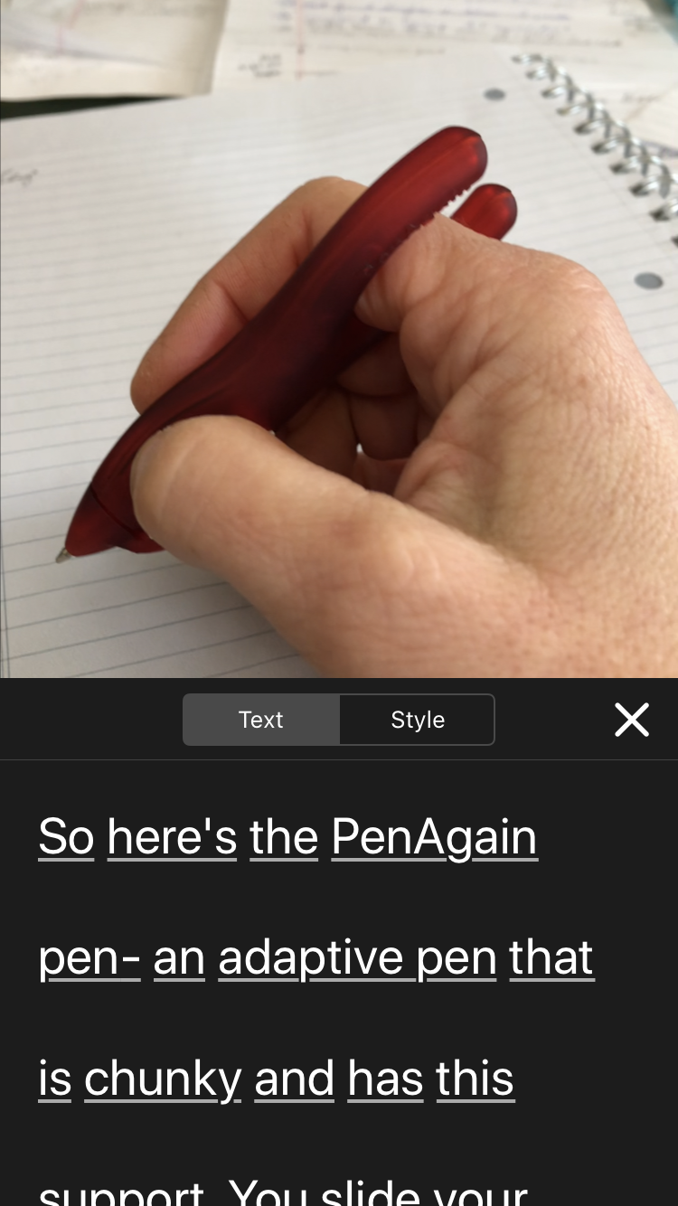 Screenshot of Clips App shows still of hand holding PenAgain over a notebook and beneath is the edit function open on Text with the words 
