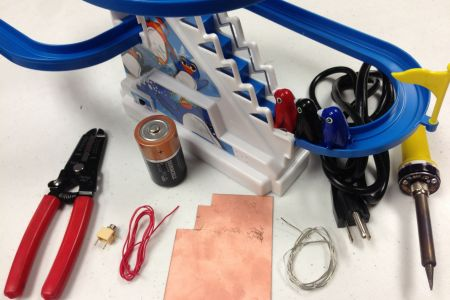 Battery-powered toy with tools and wires.