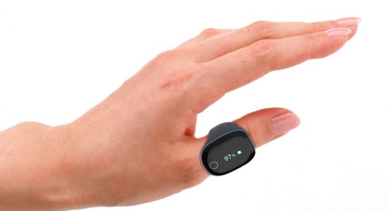 A hand wearing a sleek pulse oximeter on its thumb with a readout of 97%.