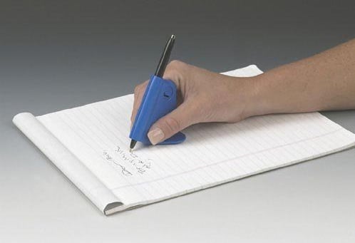 A hand writing on a notepad with a pen attached to a plastic support that folds around the pen and spreads out under the hand to stabilize against the writing surface.
